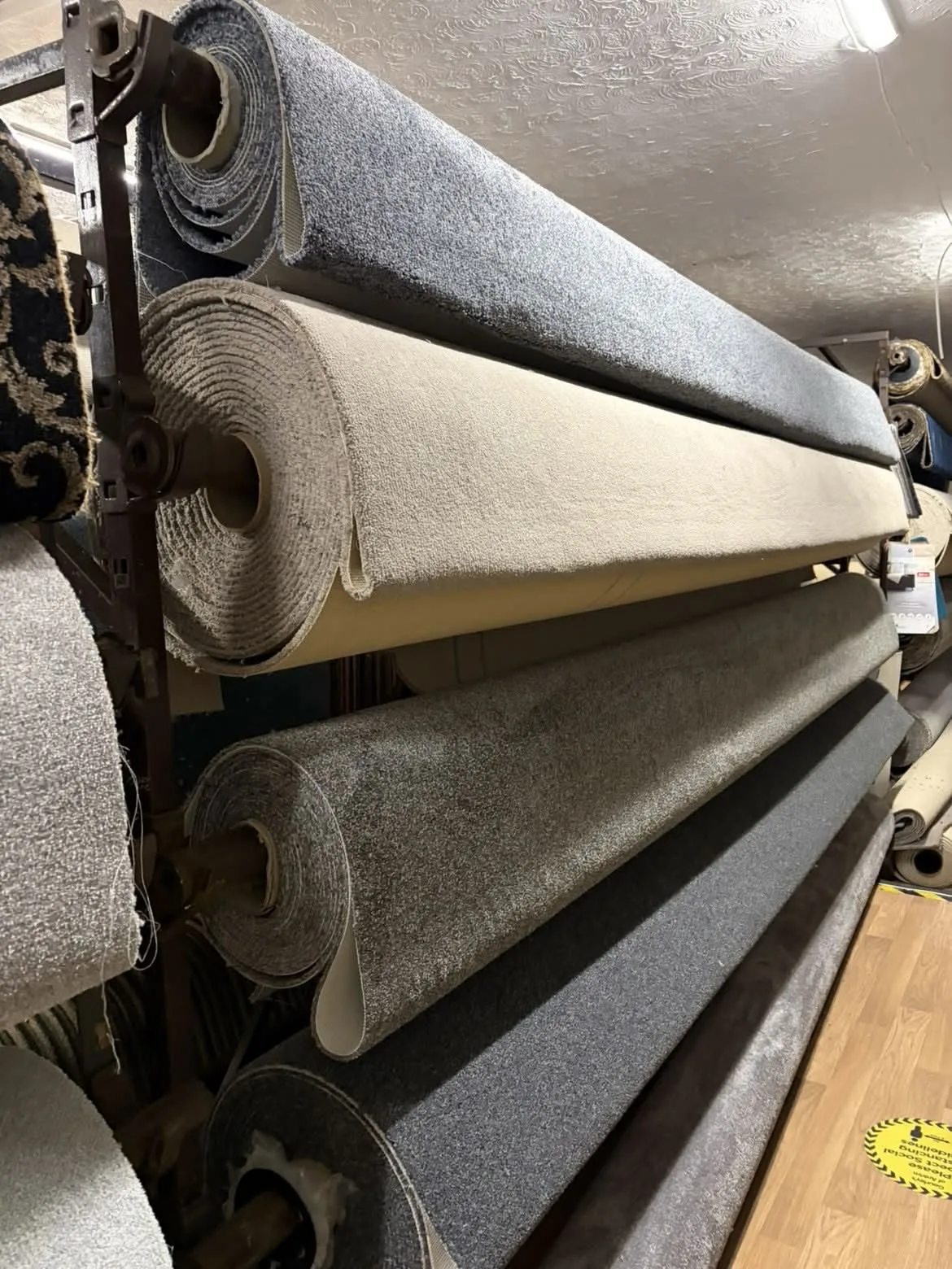 Carpet rolls on display racks at the Antrim showroom