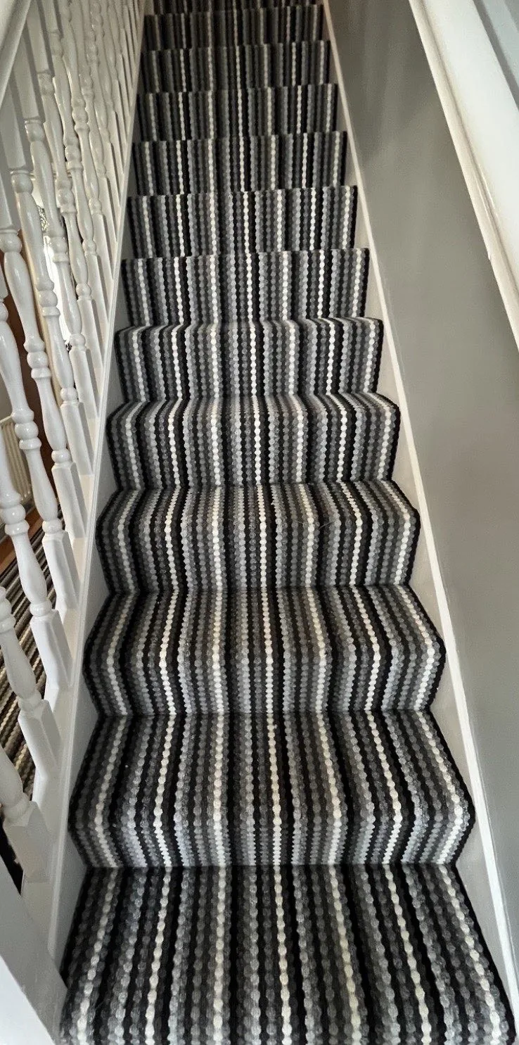 Striped stair carpet with dark and light narrow stripes