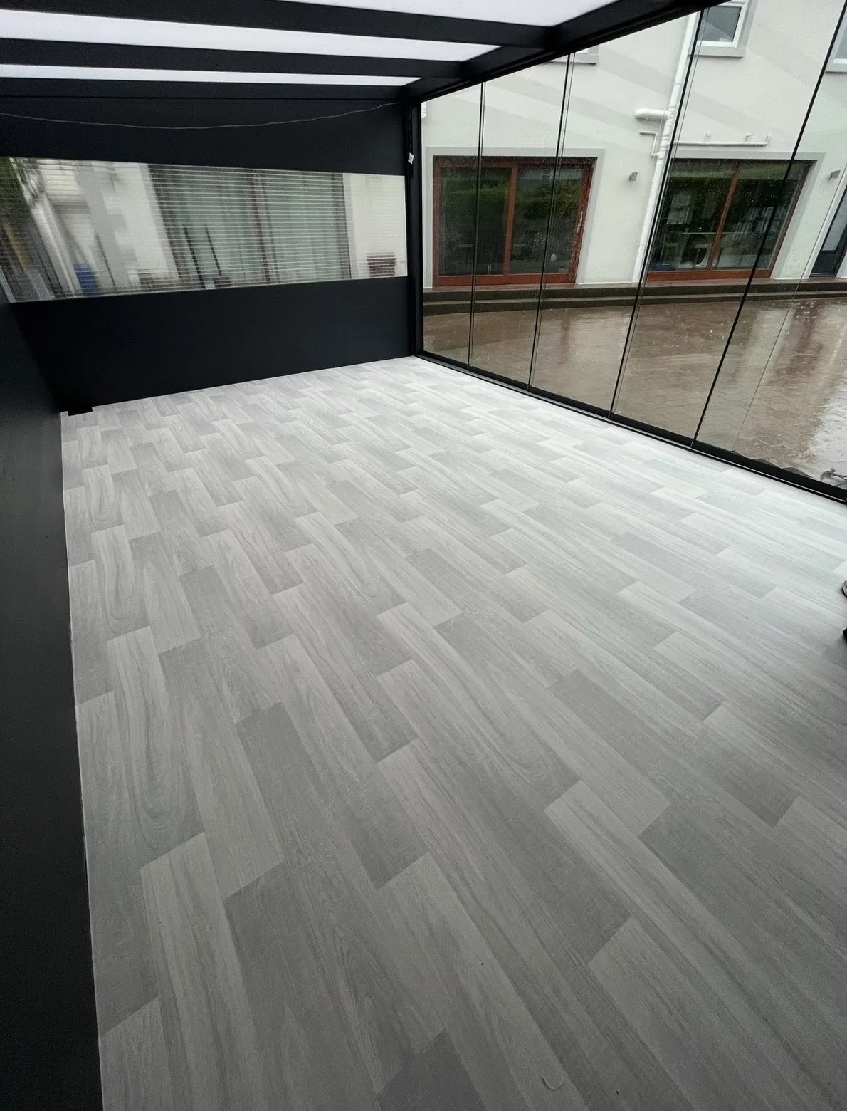 Pale wood-effect vinyl flooring in a conservatory