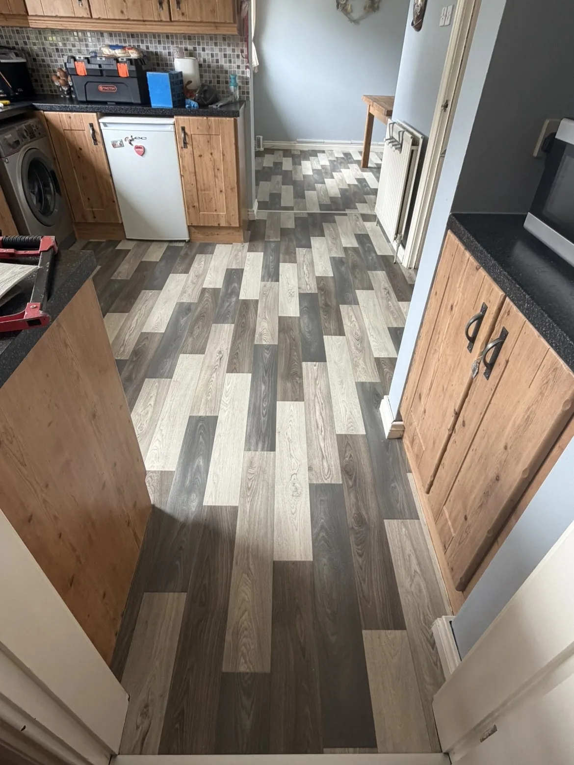 Grey wood-effect vinyl fitted in a furnished living room