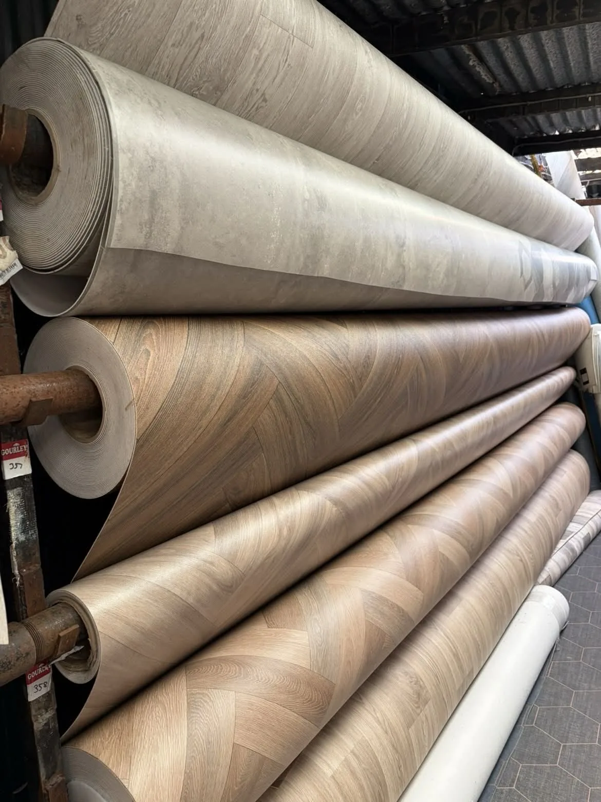 Wood-effect vinyl rolls displayed in the showroom